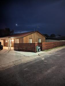 a building with a fence in front of it at Twodogfolly at Creeklands in Armidale