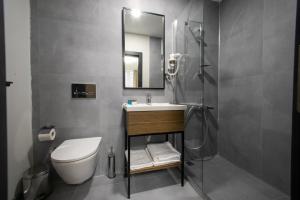 y baño con aseo, lavabo y ducha. en MAD INN HOTEL & SPA en Ankara