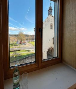 a window with a view of a castle at Hotel-Weingut Bernard in Sulzfeld am Main