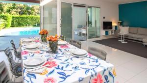 a dining table with a blue and white table cloth at Villa Riva Beachfront in Lignano Sabbiadoro +15 photos