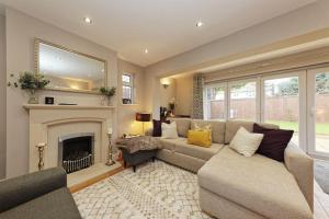a living room with a couch and a fireplace at Beautiful Beach Side 4 Bed House in Kent