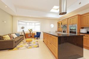 a kitchen with a large island in a living room at Beautiful Beach Side 4 Bed House in Kent