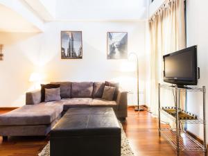 a living room with a couch and a flat screen tv at Total Valencia (Leisure & Culture) in Valencia