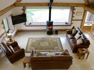 an overhead view of a living room with couches and a fireplace at Coombe View in South Redworthy