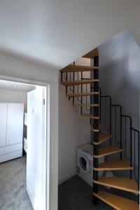 a spiral staircase in a home with a laundry room at Royal Manor Park in Llandudno