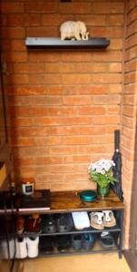 a cat sitting on a shelf next to a brick wall at Lovely 2 bedroom Flat with Free Parking in New Southgate