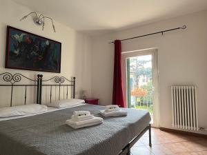 a bedroom with two towels on a bed with a window at Residenza Montecchi in Verona