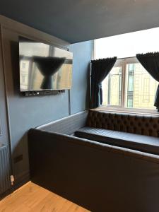 a large bed in a room with a window at Unique city centre DJ apartment - sleeps 20 in Liverpool