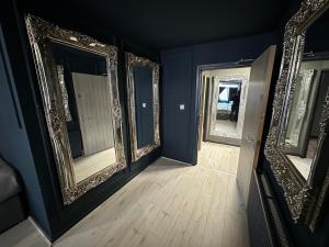a room with three mirrors and a wooden floor at Unique city centre DJ apartment - sleeps 20 in Liverpool +4 photos