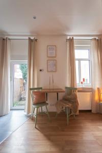 a dining room with a table and two chairs at Coole Altbau-WE 1-ZKB Terrasse Worms Zentrum in Worms