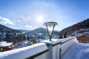 einen schneebedeckten Balkon mit einer Lampe darüber in der Unterkunft Schwarzwald Panorama in Bad Herrenalb