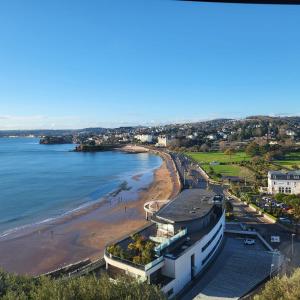 a view of the beach from the top of a building at Loveliest Homes Torquay - 3 bed, 2 bathroom, balcony, parking in Torquay