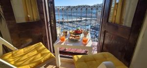 a table with a bowl of fruit on a balcony at Apartamentos Bermeo, Museoa in Bermeo