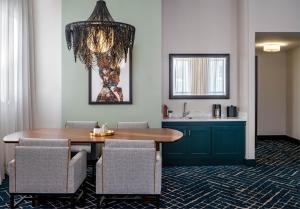 a dining room with a table and chairs at Hyatt Centric French Quarter in New Orleans