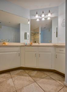 uma casa de banho com um lavatório e um espelho grande em NEW 2bed2bath condo - CLEARWATER BEACH - FREE Wi-Fi and Parking em Clearwater