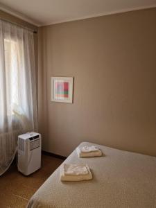 a bedroom with a bed with two towels on it at San Pietro Apartment in Padova