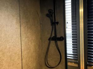 a shower with a blow dryer on a wall at Cannelle in Verviers