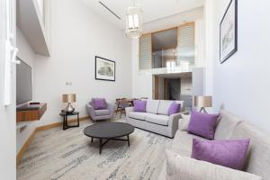 a living room with a couch and a table at Sanctum Belsize Road in London