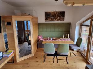 a dining room with a table and chairs at Nockalm Appartement Hochrindl 