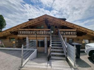 a log house with stairs in front of it at Nockalm Appartement Hochrindl 