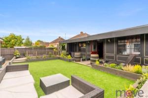 a backyard with a lawn and a house at Modern 4 bed home, hottub and traditional pub in Down Hatherley