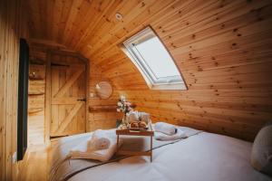 a bedroom with a bed in a wooden room at Daisy in Rhayader