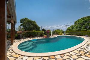 a swimming pool in the middle of a house at Charmant Studio Climatisé à Sainte Suzanne. in Commune Bègue