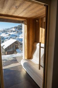 a room with a window with a view of a snow covered mountain at Villa Carolina in Selva di Val Gardena