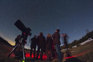 a group of people looking at the night sky at Bonansa Country Hotel in Bonansa