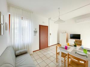 a living room with a couch and a table at Homiday - Appartamenti Pinetina in Pineto