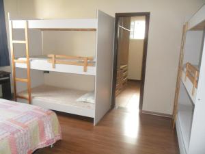 a room with two bunk beds and a closet at Casa e Salao Botanico in Curitiba