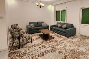 a living room with a couch and a table and chairs at 3BDR GREAT location, Spacious and family-friendly. in Umm Uthainah