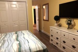 a bedroom with a bed and a dresser with a television at SunSet Terrace, Avon NC in Avon