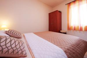 Postel nebo postele na pokoji v ubytování Apartments Ivica