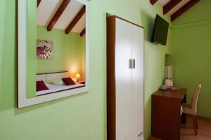- une chambre avec un lit et un miroir dans l'établissement Apartments Ivica, à Trogir