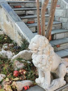 a white statue of a lion sitting on the stairs at 160 s.m unique luxury house in Nea Kallikrateia
