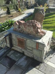a statue of a lion sitting on a stone bench at 160 s.m unique luxury house in Nea Kallikrateia