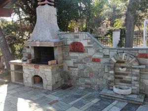 an outdoor pizza oven with a stone wall at 160 s.m unique luxury house in Nea Kallikrateia