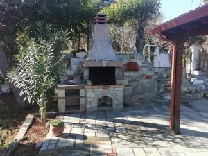 a stone oven in a yard with a patio at 160 s.m unique luxury house in Nea Kallikrateia