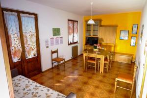 a living room with a table and a dining room at Residence ai Tovi in Ledro