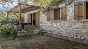 a stone house with a porch and a wooden deck at Villa Colombo in Bonifacio