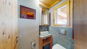 a bathroom with a sink and a window at Etoiles des Neiges LUXE & JACUZZI chalet 12 pers by Alpvision Résidences in Hérémence +23 photos