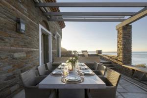 a table on a patio with a view of the ocean at Seaview Beach House in Andros