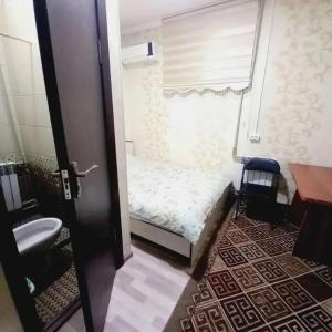 a small bedroom with a small bed and a window at Hostel Sulaiman-Too in Osh
