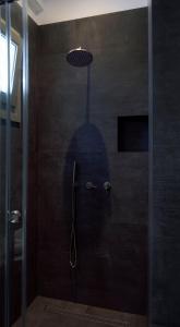 a shadow of a person in a shower stall at Nautilus Serifos in Livadakia