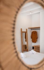 a room with a bed and a mirror at Nautilus Serifos in Livadakia