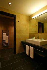 a bathroom with a sink and a mirror at Falconara Greenblu Resort in Licata