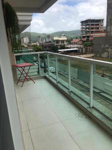 balcón con mesa y vistas a la ciudad en Apartamento encantador, 100 m do mar, en Porto Belo