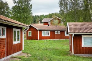 a row of red houses in a yard at First Camp Lugnet-Falun in Falun