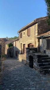 a cobblestone street in an old stone building at appartement chez l'artiste in Minerve